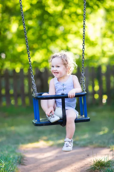Girl having fun on a swing ride — Stock Photo, Image