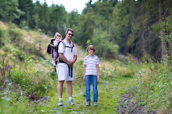 Glückliche junge Familie wandert in einem wunderschönen Herbstwald — Stockfoto