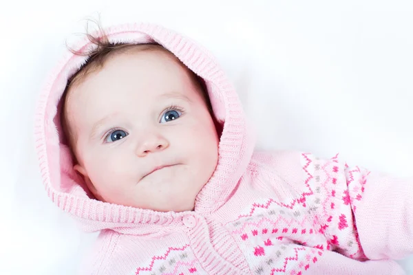 Baby girl in a pink knitted jacket with red hearts — Stock Photo, Image