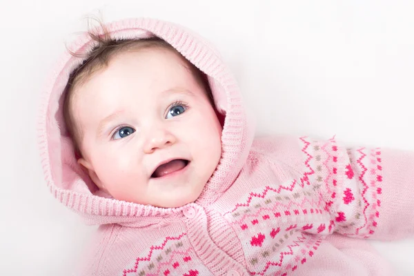 Baby girl in a pink jacket with hearts pattern — Stock Photo, Image