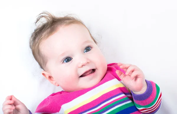 Menina bebê em um vestido colorido de malha Imagens Royalty-Free