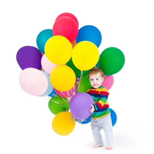 Baby playing with party balloons — Stock Photo, Image