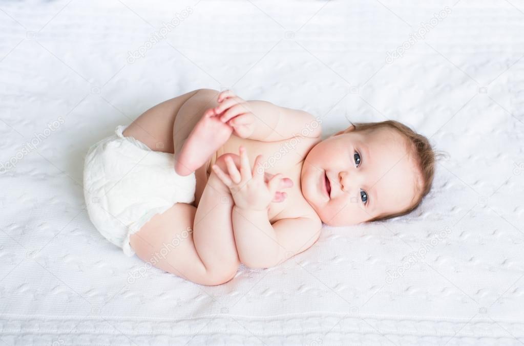 Baby playing with its feet Stock Photo by ©FamVeldman 43243045