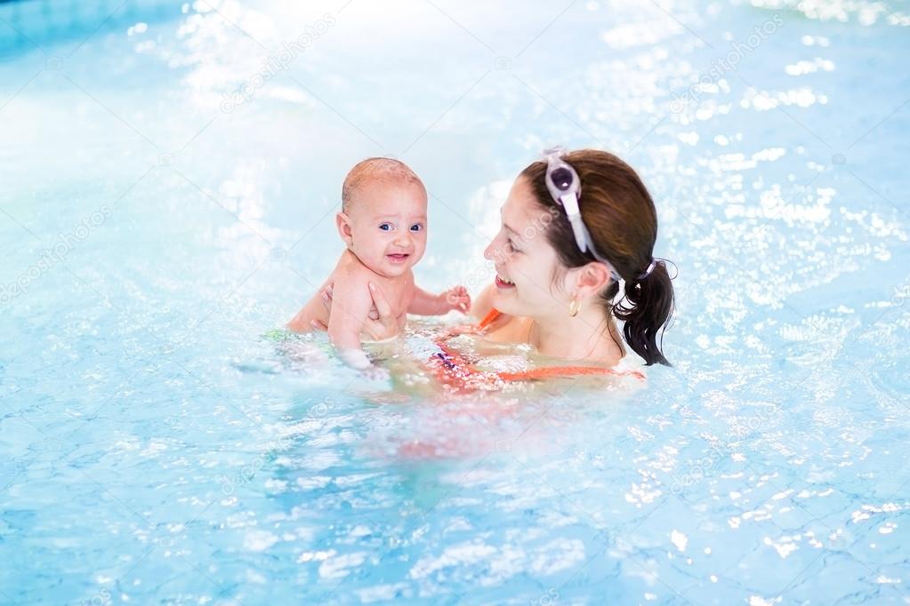 Baby in a swimming pool with mother