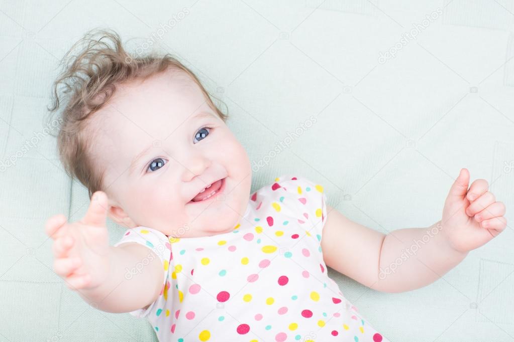 Baby girl on a green blanket