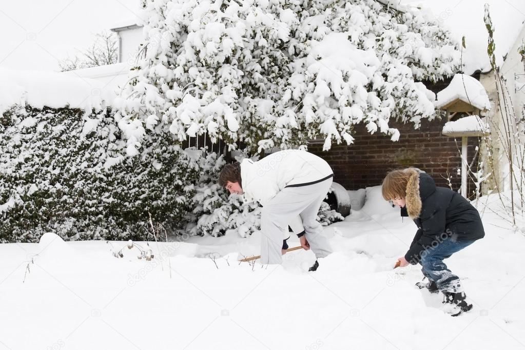 Father and son shoveling snow