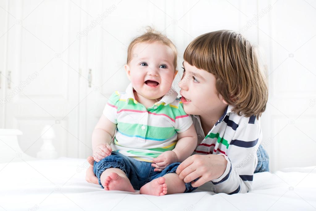 Boy talking to his baby sister