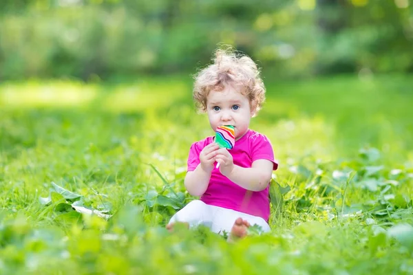 Baby girl eating candy — Stock Photo, Image