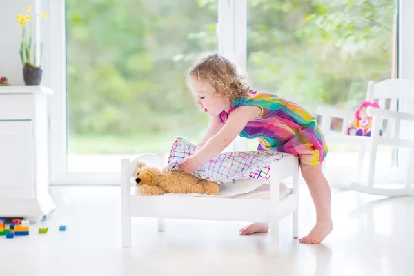 Toddler girl with her toy bear — Stock Photo, Image