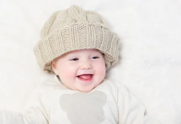 Little baby in a huge knitted hat — Stock Photo, Image