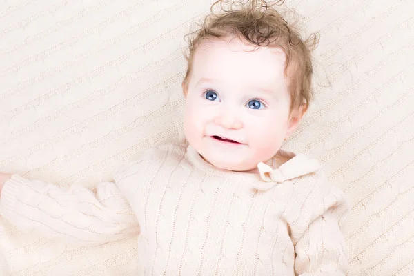 Baby girl on a cable knit blanket — Stock Photo, Image