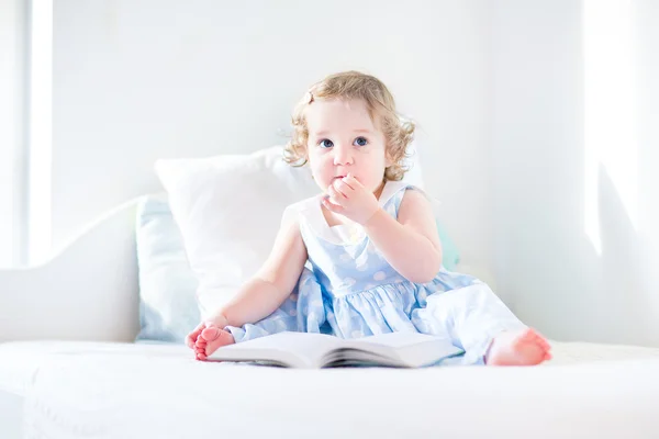 Little toddler girl reading a book — Stock Photo, Image