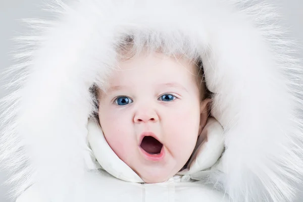 Baby girl wearing a big fur hat — Stock Photo, Image