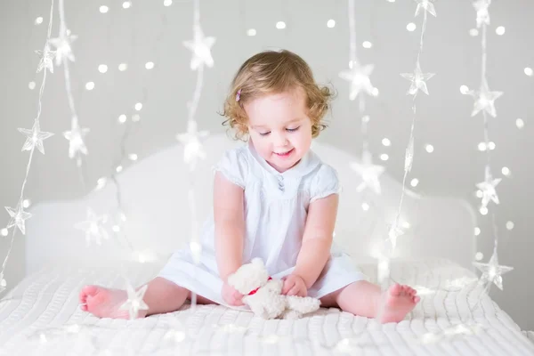 Toddler girl  playing with toy bear — Stock Photo, Image