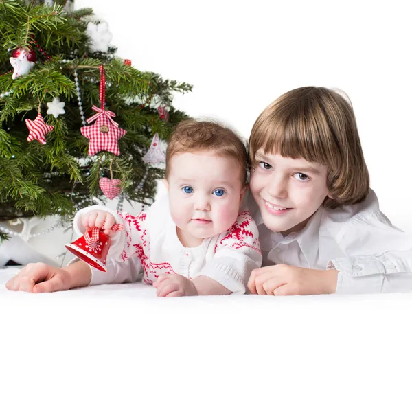 Christmas portrait of a little boy and his adorable baby sister — Stock Photo, Image