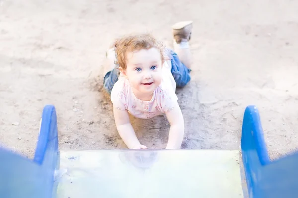 Girl playing on a slide — Stock Photo, Image
