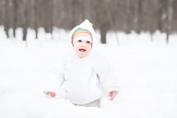 Baby digging in the snow — Stock Photo, Image