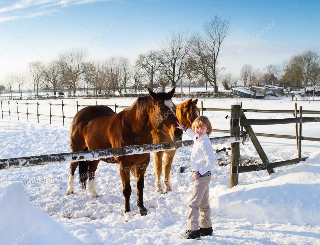 Boy playing with horses