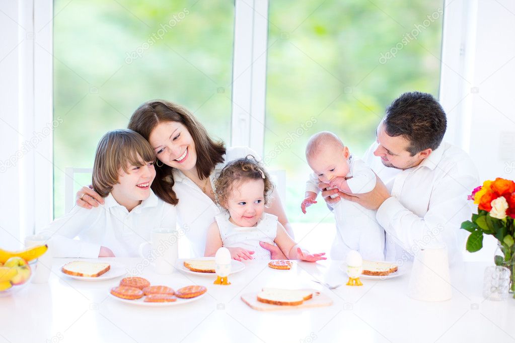 Family with three children having fun together during an Easter breakfast