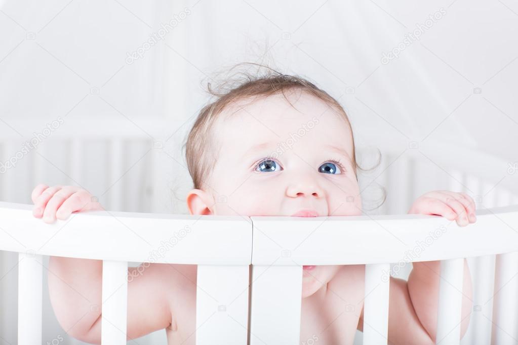 Baby biting on a crib Stock Photo by ©FamVeldman 43250995