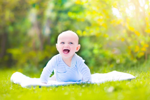 Cute laughing baby in the garden — Stock Photo, Image