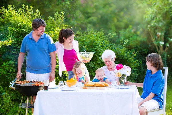 Big family grilling meat for lunch — Stock Photo, Image