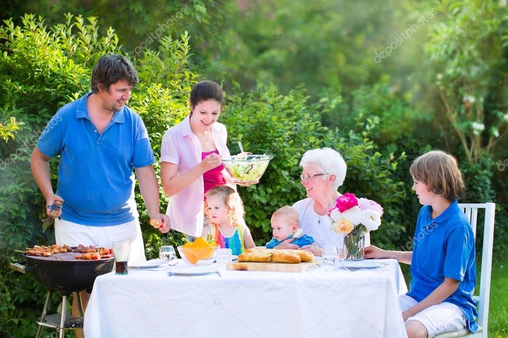 Big family grilling meat for lunch