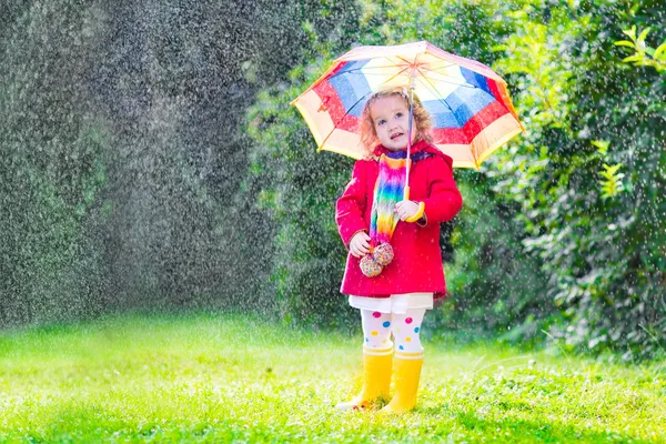 小さな女の子が雨の中で遊んで — ストック写真