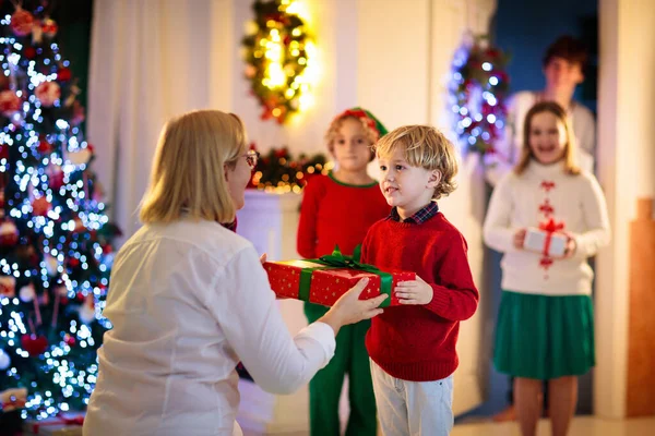 Family Visiting Grandmother Christmas Day Kids Gifts Home Front Door — Stock Photo, Image