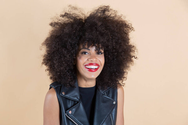 pretty afro american woman smiling with leather clothes