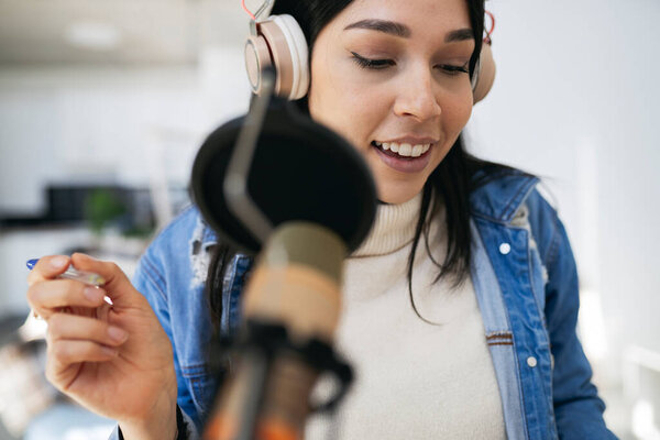 pretty Hispanic woman, who has a podcast and works from home