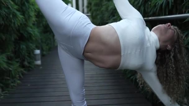 Curly Haired Blonde Woman Does Yoga Indoors Plants — Stockvideo