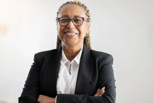 old business woman with afro american glasses - concept of woman in office working before retirement -