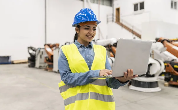 Hispanic engineer woman with computer in factory