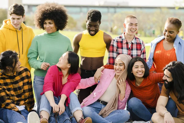 cheerful multiracial group of happy friends in the park having fun