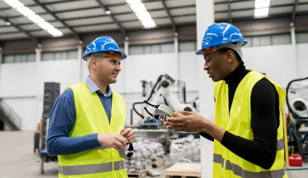 engineering man and mechanical worker doing routine check in industrial factory