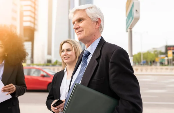 senior business man leaving work with colleagues, Business People Standing outdoor and Discussing