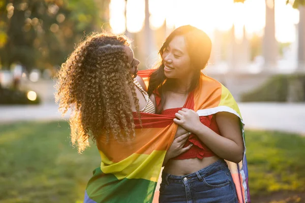 Two Multiethnic Girlfriends Lgbt Rainbow Flag Hugging Sunset — Foto de Stock