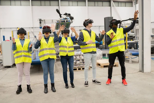 engineers in factory, with metaverse virtual reality glasses