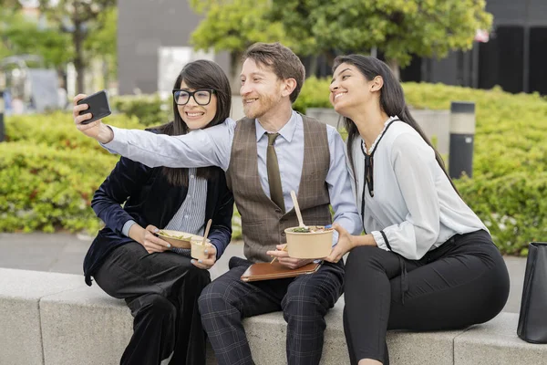 Three diverse co-workers take a selfie on the way out