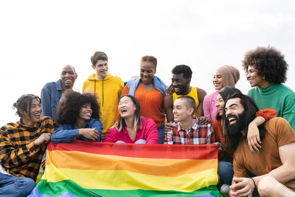 Diverse multiracial young people being friends celebrating gay pride festival - LGBTQ community concept