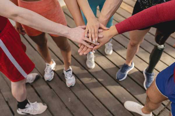 Close-up of high five hands gesture, teamwork symbol, people planning to reach their goal, start working together. Fitness success and teamwork concept