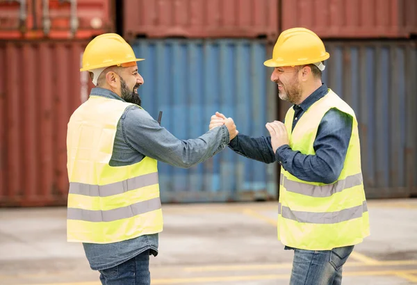 port cargo workers shake hands greeting each other