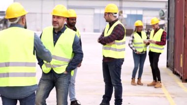 Gümrük ve mal limanında çalışan bir grup işçi. arka plandaki kişilere odaklan