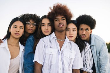 Happy friends from diverse cultures and races taking photo making funny faces - Youth, millennial generation and friendship concept with young people having fun together