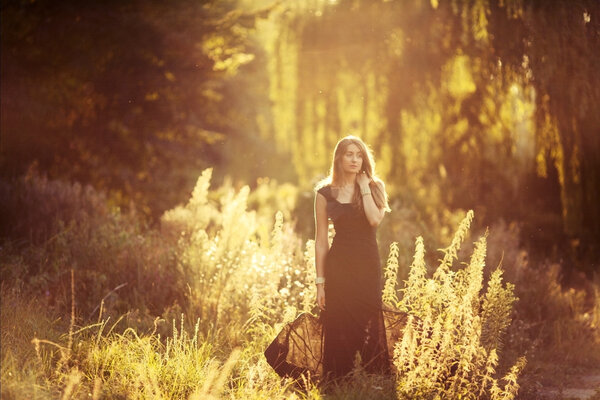 Girl on a walk in the woods, sun-drenched photo
