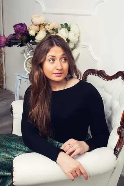 Attractive girl in a beautiful white chair — Stock Photo, Image