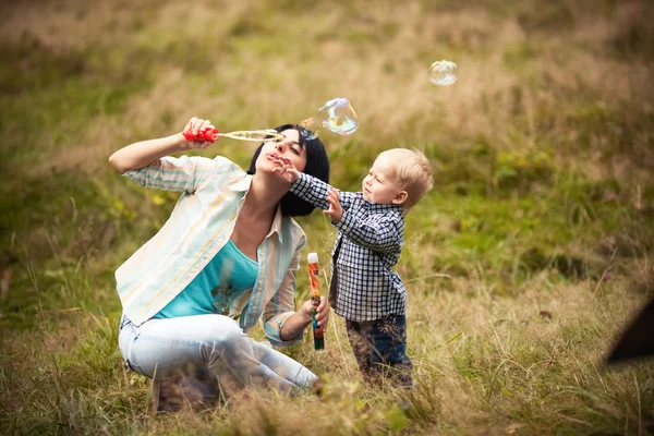 Menino com bolhas com a mãe — Fotografia de Stock