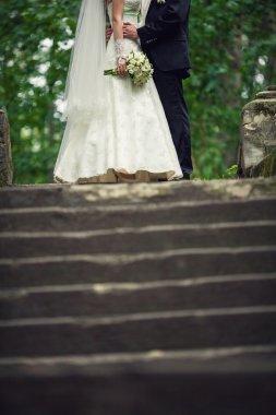 düğün. Gelin ve damat güzel bir buket çiçek ile belgili tanımlık merdiven üstünde kucaklayan