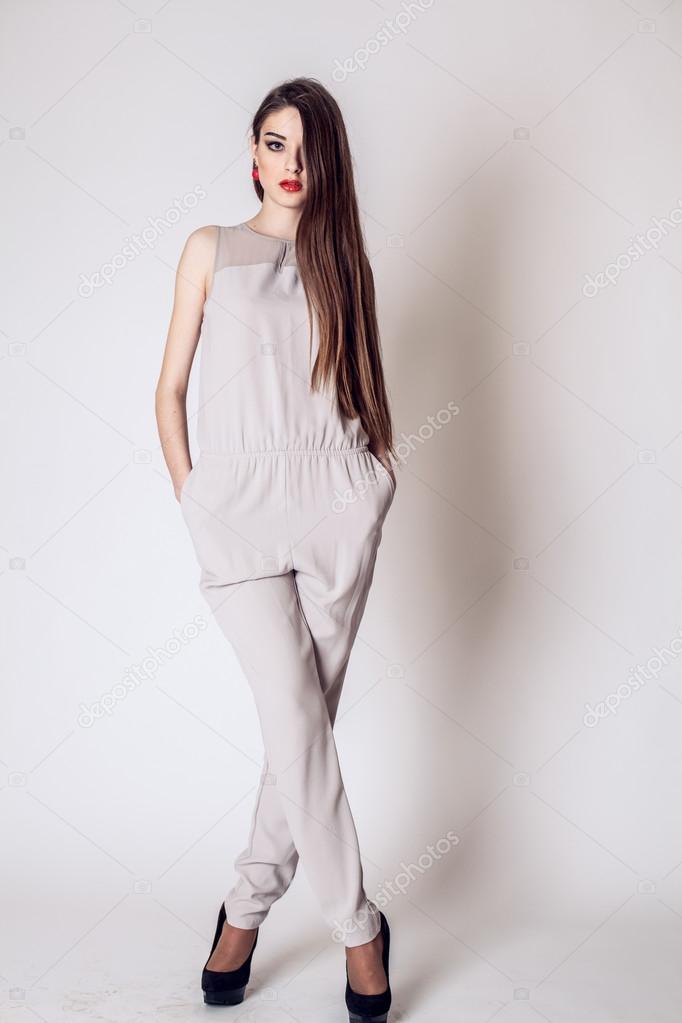 Fashion photo of young woman in beige. Fashion photo